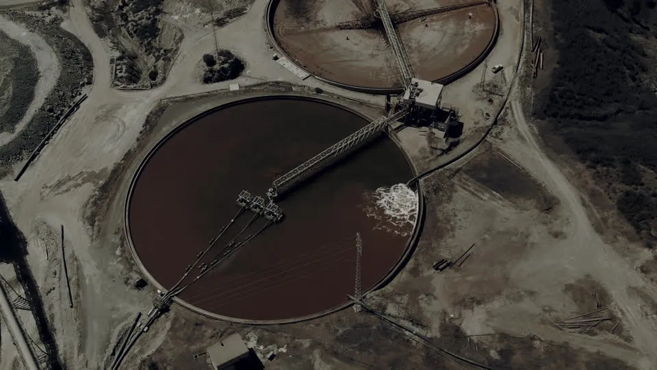 Aerial view of turbid, sediment laden clarifier ponds: untreated industrial wastewater